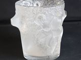a frosted glass vase with a flower design on it