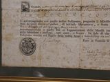 an old document on display in a glass case
