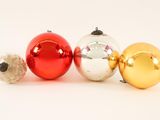 four christmas ornaments are lined up in a row on a white surface