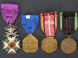 several medals are arranged in a row on a black surface