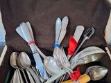 silverware in a black case with a red bow on top of it