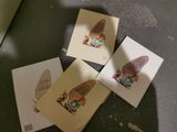 four cards with a picture of a gnome on them sitting on a table