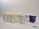 several tubes of sunscreen creams are lined up on a table
