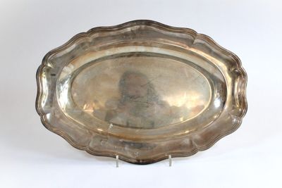 an old silver plate with a picture of a man on it