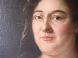 portrait of a woman in a white dress with a feathered headband