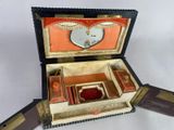 a small box with a mirror in it on a table