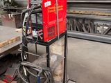 a machine that is sitting on a cart in a warehouse