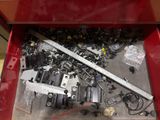 a red box filled with assorted tools and screws
