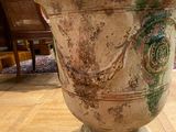 a large vase sitting on a wooden floor in a living room