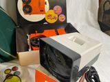 a small television sitting on top of a box next to other items