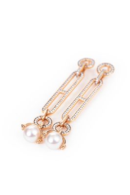 a pair of pearl and gold earrings on a white background