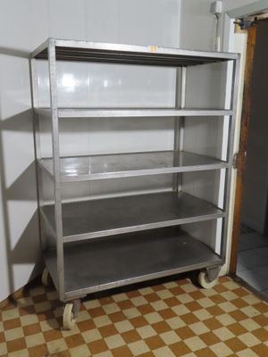 a metal shelf in the corner of a room