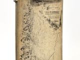 an old book with a map on it sitting on top of a table