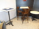 a small table and chairs in a small room