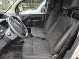 the interior of a small car with a steering wheel and a dashboard