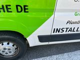 a green and white van parked in a parking lot