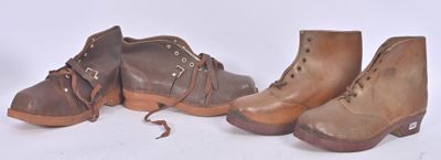 three pairs of brown boots sitting next to each other on a white surface
