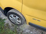 a yellow car that is parked on the side of the road
