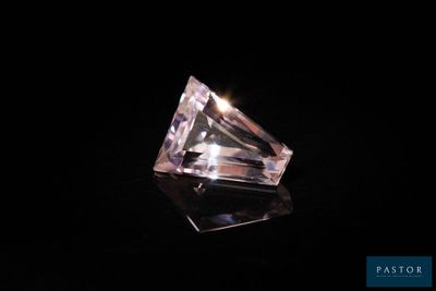 a pink diamond on a black background