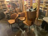 a room with a lot of chairs and a table in it