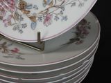 several plates stacked on top of each other on a black surface
