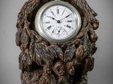 a clock that is sitting on a tree stump