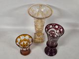 three glass vases sitting next to each other on a table