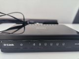 a black d - link router on a white table