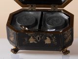 a black and gold box with two plates inside of it