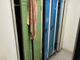 several lockers in the hallway of a building with a towel hanging on the door