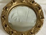 a mirror that is sitting on a white sheet