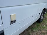 a white van that is parked in the grass