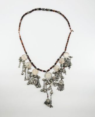 the necklace is made of silver and brown beads