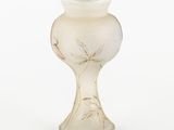 a glass vase that has a design on it