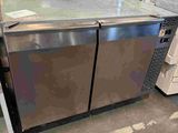 stainless steel double door refrigerators in a warehouse with boxes and other items