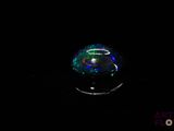 a close up of a glass ball in the dark on a table