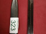 two knives on a red cloth with a price tag
