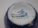 a blue and white vase with a picture of a horse on it