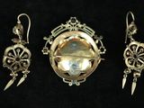 three pieces of jewelry are displayed on a black surface