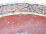 a close up of a red bowl with flowers on it