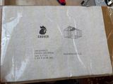 a box that is sitting on a table with a bird in it