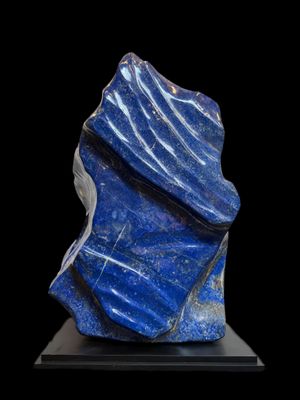 a blue stone sculpture on a black base