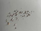 a lot of tiny tiny diamonds on a white surface