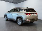 a silver suv that is parked in a showroom