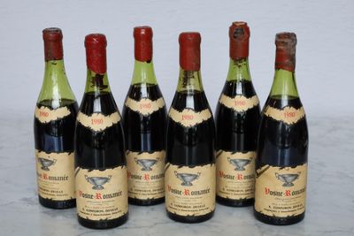 six bottles of wine are lined up on a marble surface