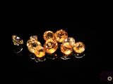 some yellow diamonds are sitting on a black surface