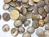 a pile of old buttons on a white surface