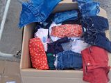 a box full of clothes sitting on the ground