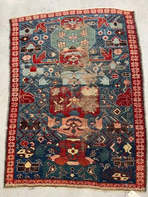 a blue and red rug on a white floor