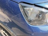 a close up of a car ' s headlight on the side of the road
